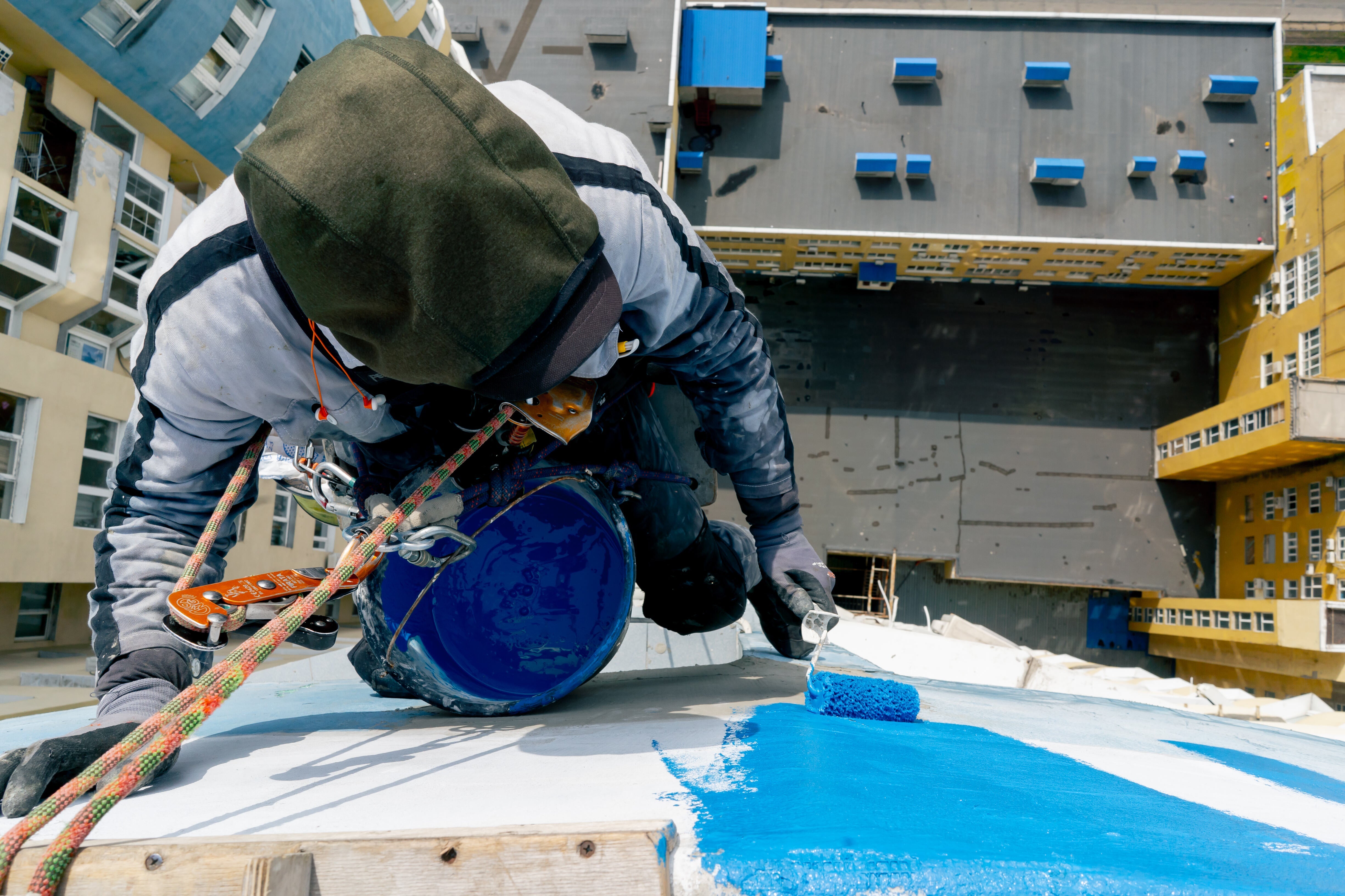Professional waterproofing membrane application on an exposed concrete roof