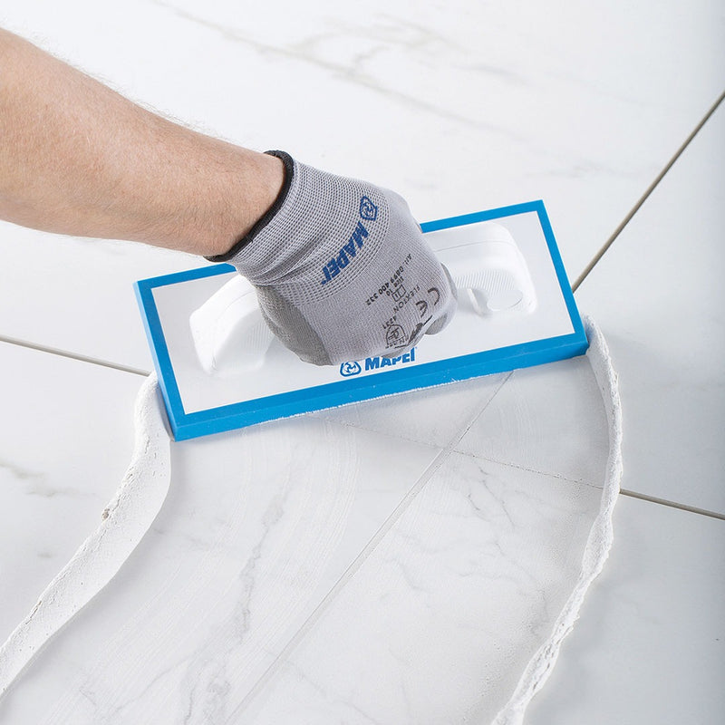 Applying Mapei Kerapoxy Easy Design epoxy grout with a rubber grout float